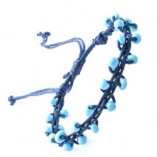 Bracelet of dark blue string decorated with beads