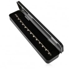 Elongated metal box in black hue for chain and watch, matt surface