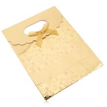Gift bag made of paper, shiny surface in golden hue, hearts, spirals, strips