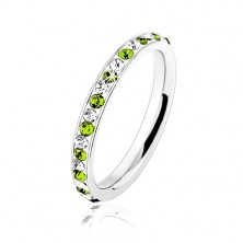 Steel ring in silver colour, clear and light green zircons