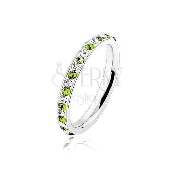 Steel ring in silver colour, clear and light green zircons