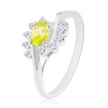 Ring with split shoulders, arcs composed of clear zircons, coloured zircon oval