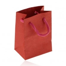 Small paper bag for gift, matt surface in red hue, pattern of roses