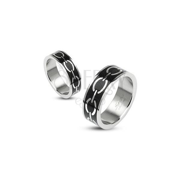 Ring with a silver chain decoration on the black background